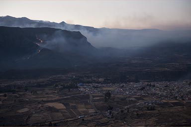 Some people set fire on mountain behind Chivay.