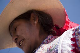 She offers a fermented drink of Mais/Corn, Huambo, bull fight, Quechua woman with hat. Peru.