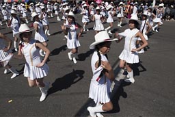 Girls dressed white, short skirts and white hats, Arequipa Day parade, Peru. 
