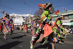 Some groups rush by, in an Andino run, parade on Arequipa Day, Peru.
