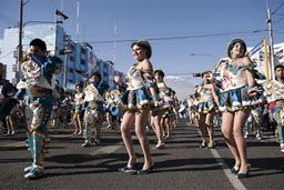 Shine and glitter, a dance group on Arequipa Day on Avenida de Independencia, the volcano Misti in back. Peru.