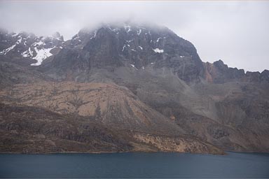 East of Lima 4,700m, a lake and snowy Andean mountains, clouds.
