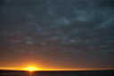 Pacific sunset under a dark cloud. Mancora, Peru.