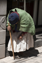 Hunchbacked old woman in Puno, Peru.